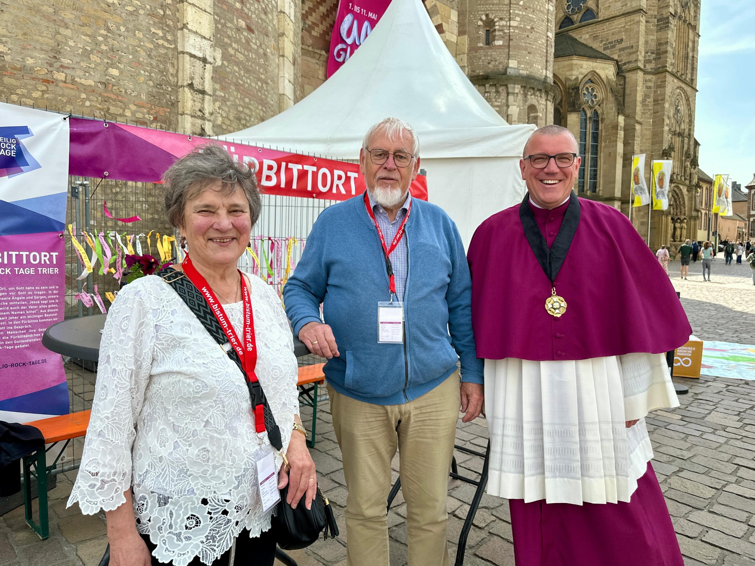 Drei ältere Menschen stehen vor dem Dom